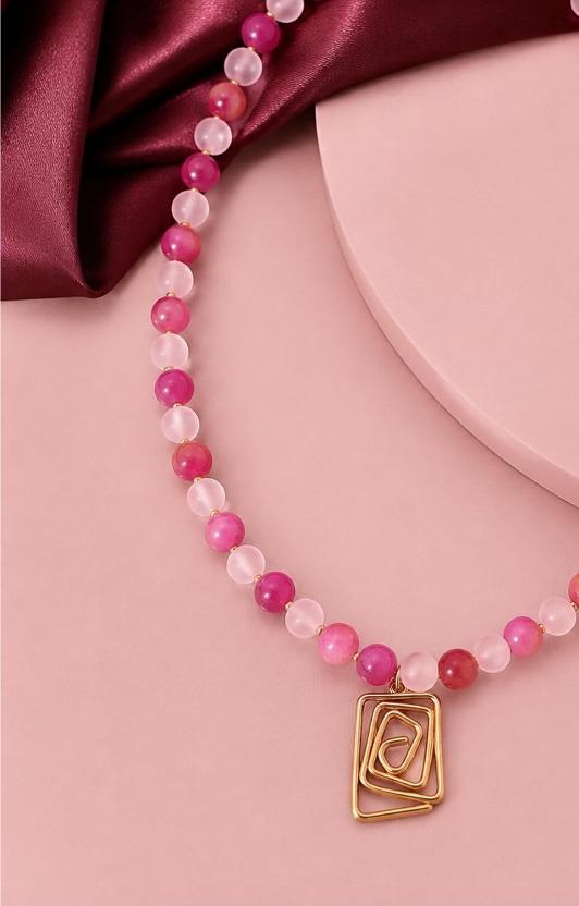 Rosalie — rose-quartz and fuchsia agate beads with a gold squared-spiral pendant on burgundy satin
